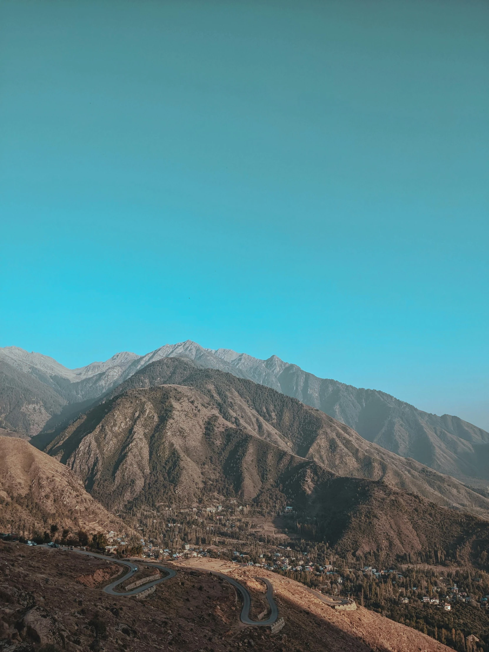 a view from a hill looking down at a town