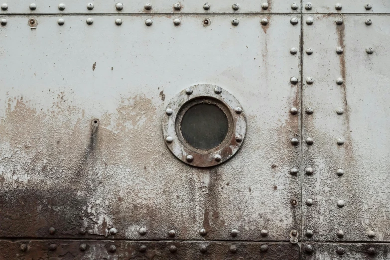 the rivets and round hole on the side of an industrial building