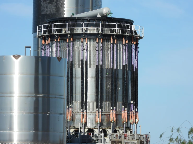 the large tower has many metal pipes running through it