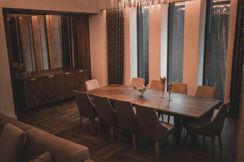 dining table in an apartment with wood floors and chandelier