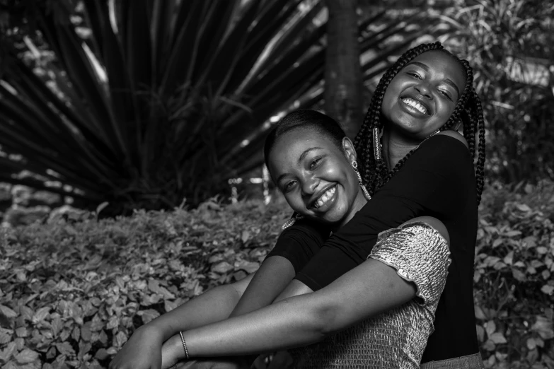 two woman laughing together in the woods