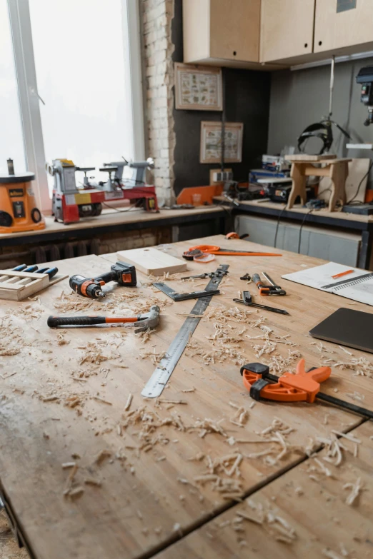 some tools and construction materials sitting on a wooden table