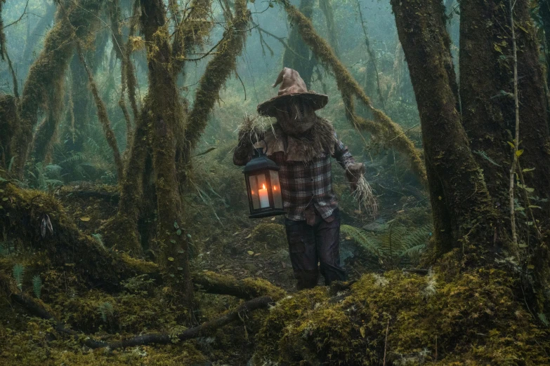 a man in the forest with a lantern and a lantern