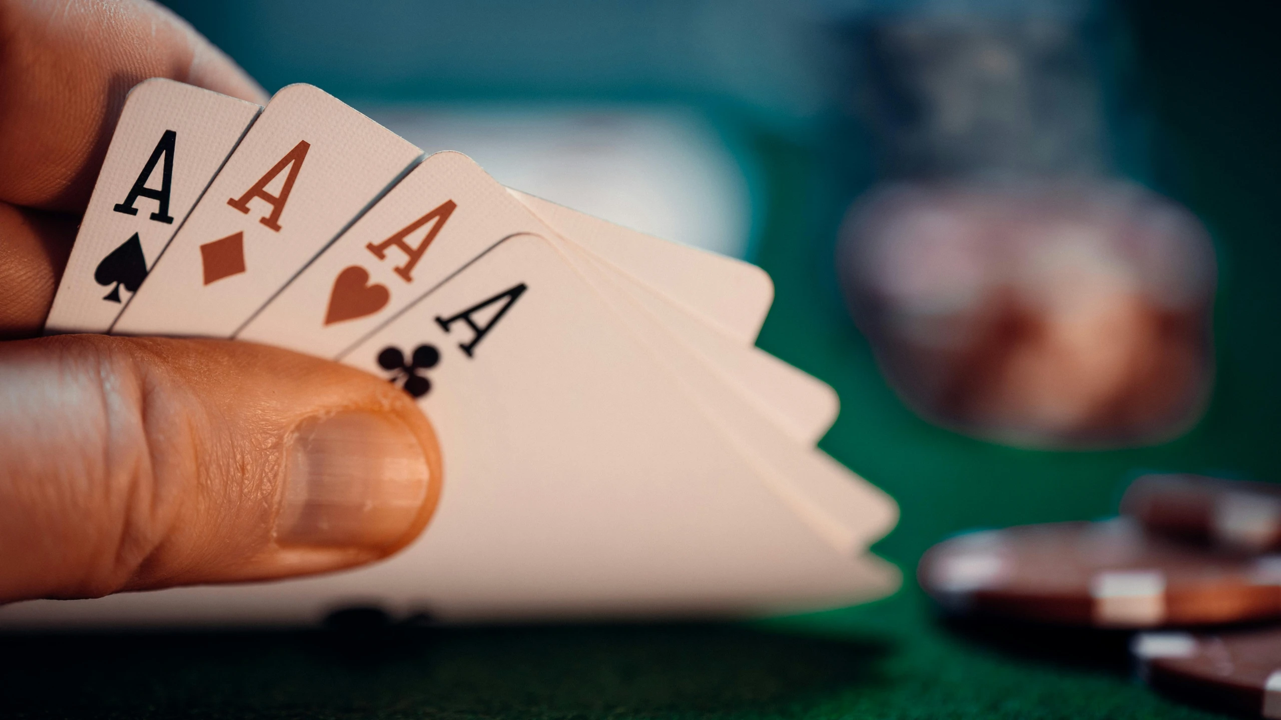 a man is holding two poker cards in their hands