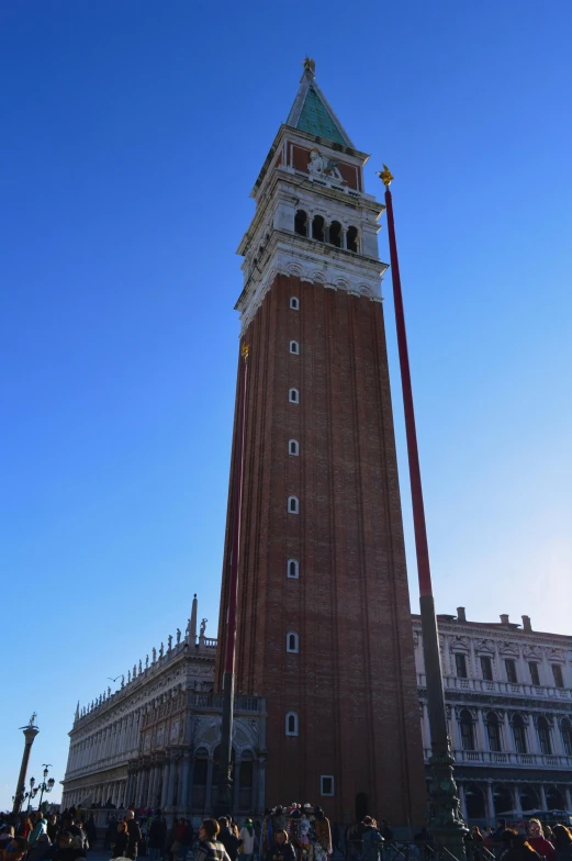 a tall brick clock tower standing in front of a building