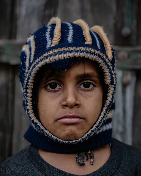 a close up of a child wearing a hat