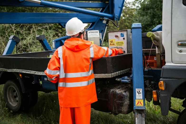 a man standing on a trailer with his hands in the back of it