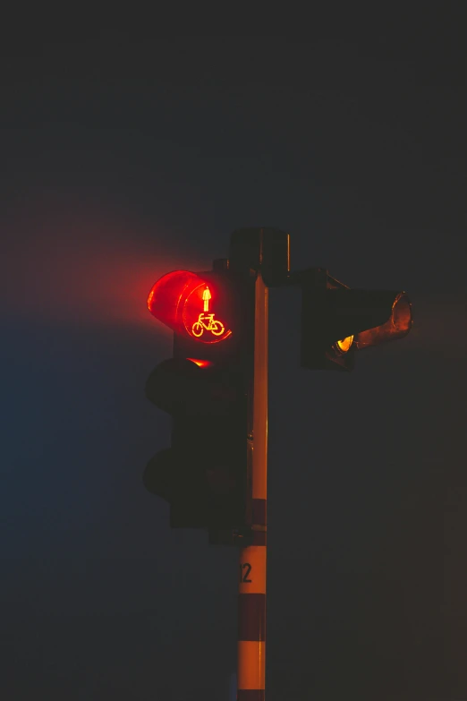 a stoplight at night with the lights red