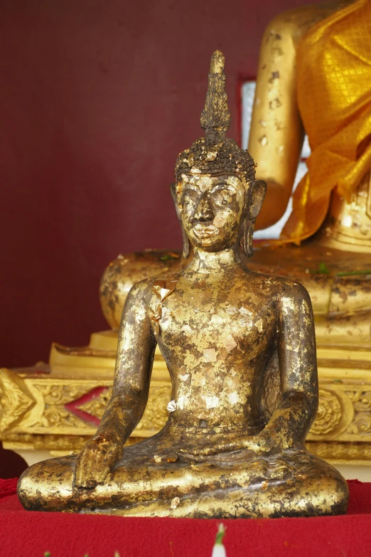 a golden buddha statue sits in the middle of a room