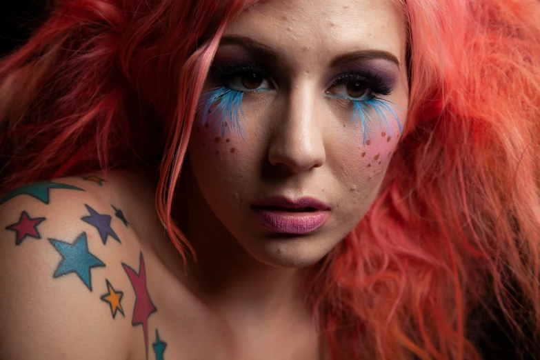 a pretty young woman with blue and pink hair