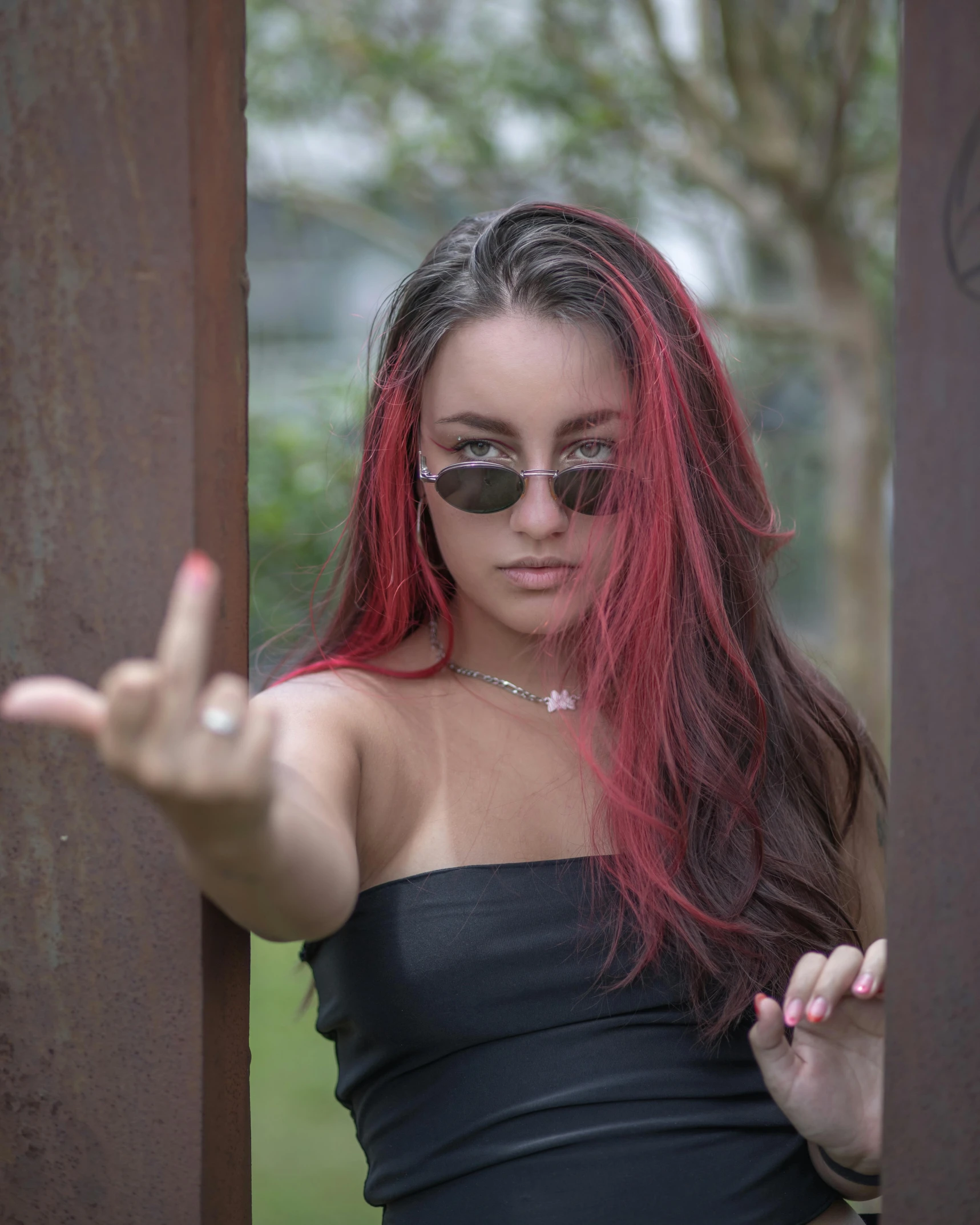 woman with long red hair in black dress posing