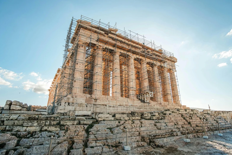 a large structure on top of rocks under a blue sky