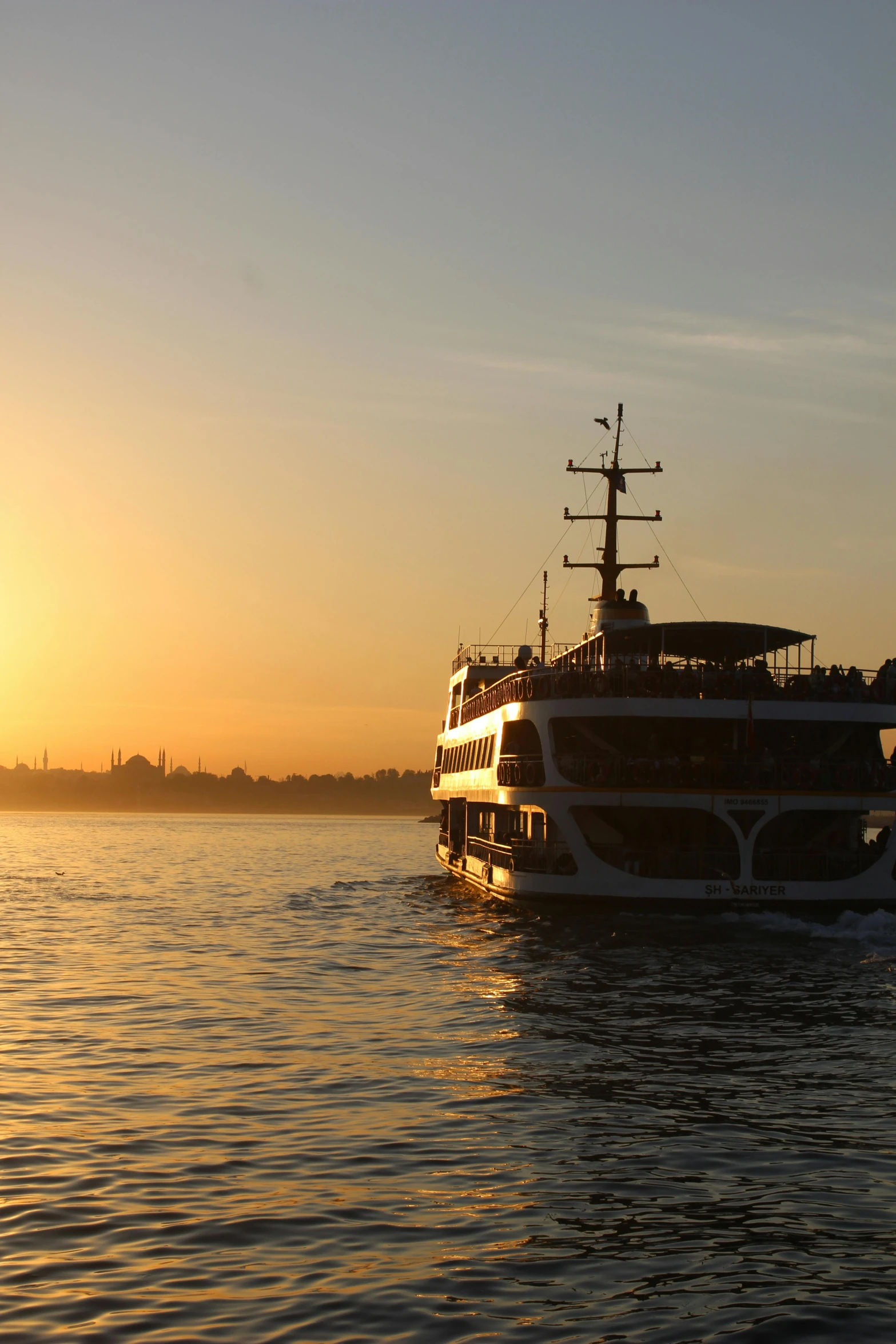 a boat is floating on the water during sunset