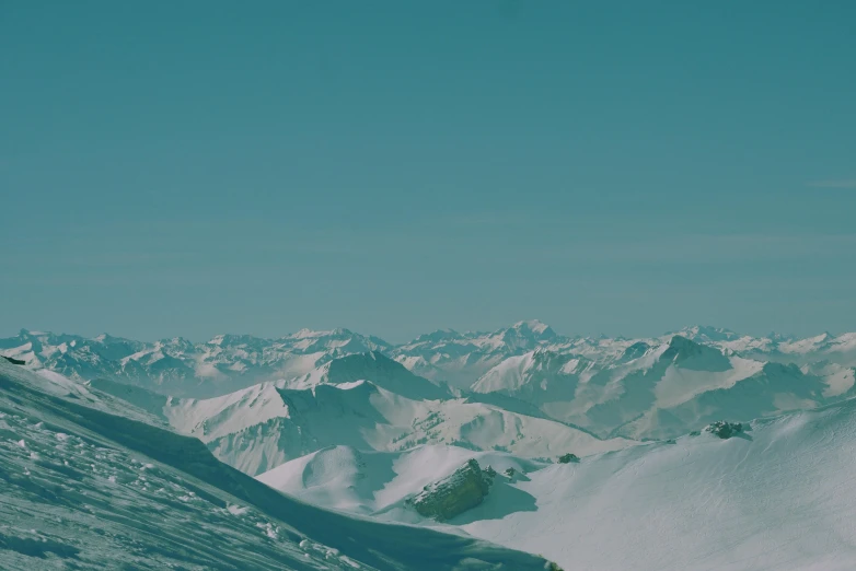 a person riding skis on top of a snow covered slope