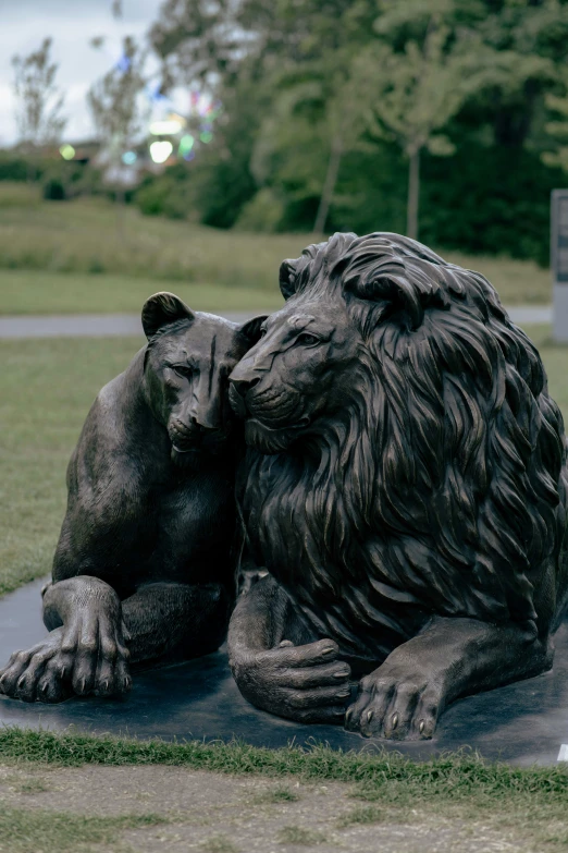 a statue of two bears resting on top of each other