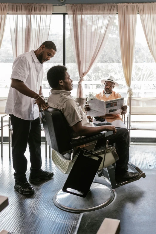 a man in the hair salon looking at another man