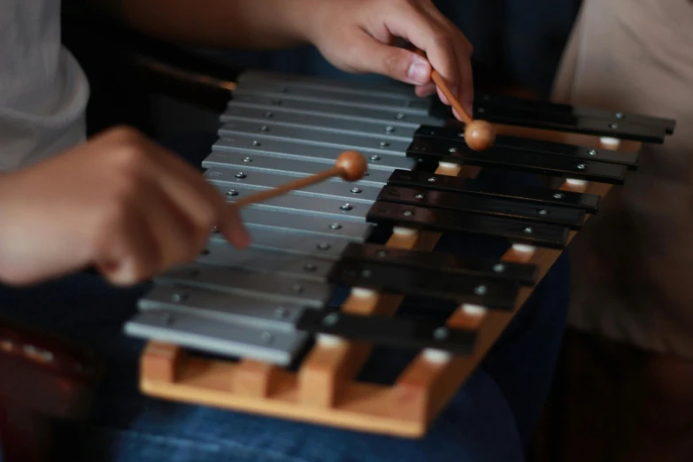 the fingers of a child playing the xylamp