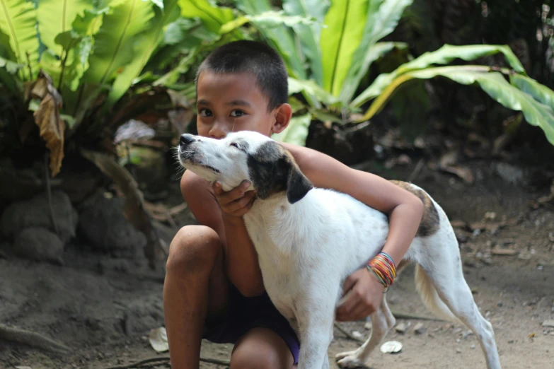 a boy and his dog are smiling together