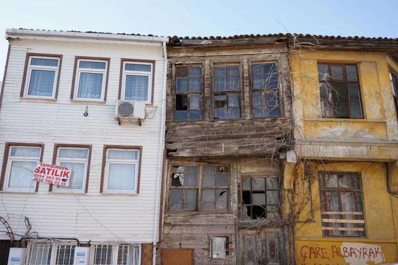 an old, rundown building next to another old one