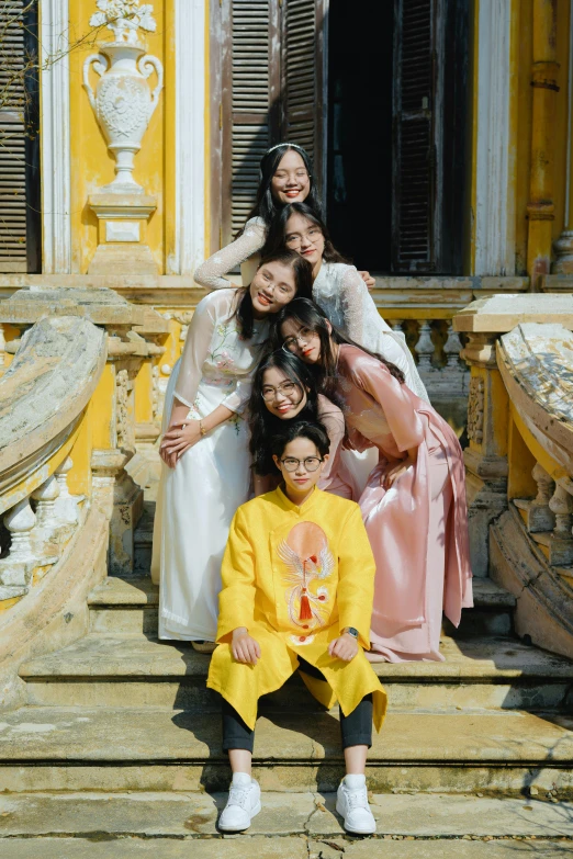 a family poses on steps in front of a building