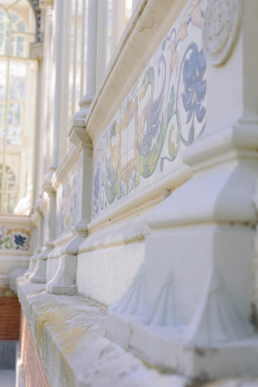 an intricately decorated wall in front of a stained glass church