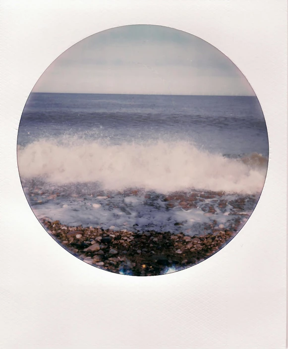 a round frame holding waves coming into the ocean