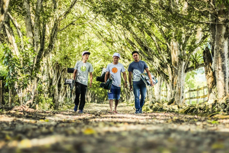 two men are walking down the path through the trees