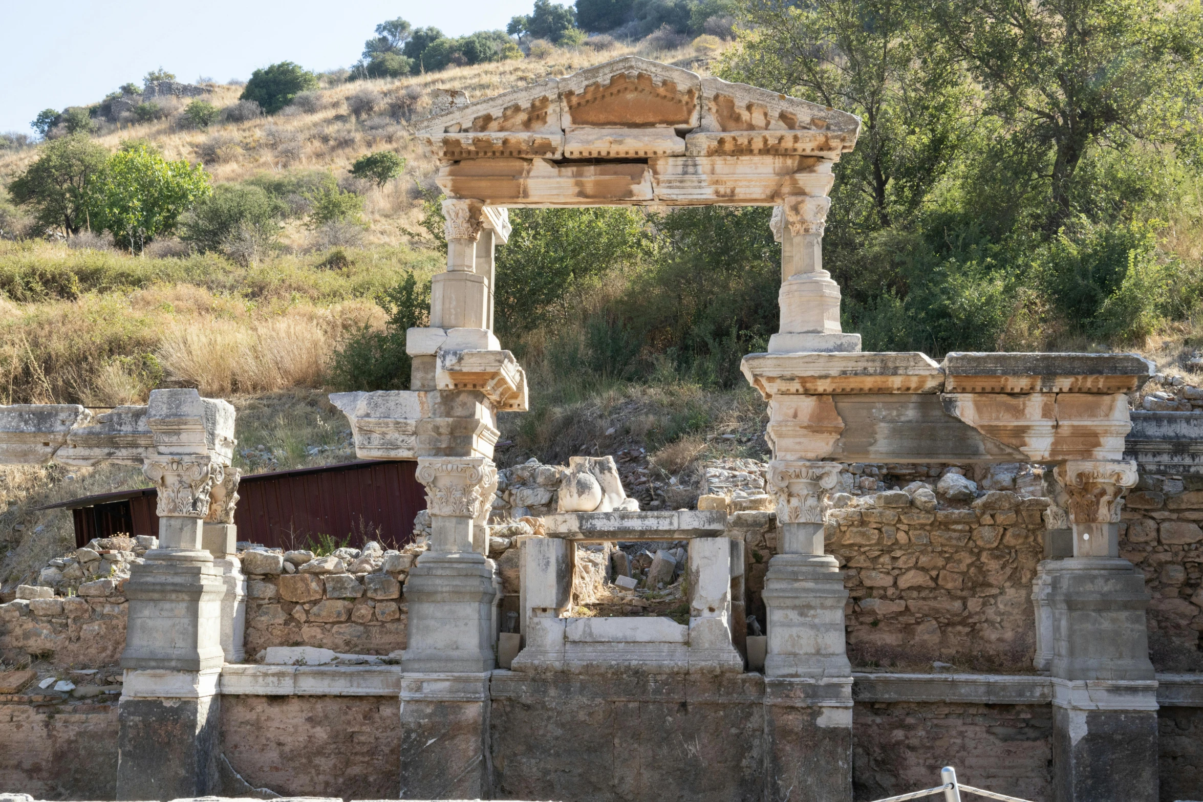 two stone sculptures and a gate on a mountain