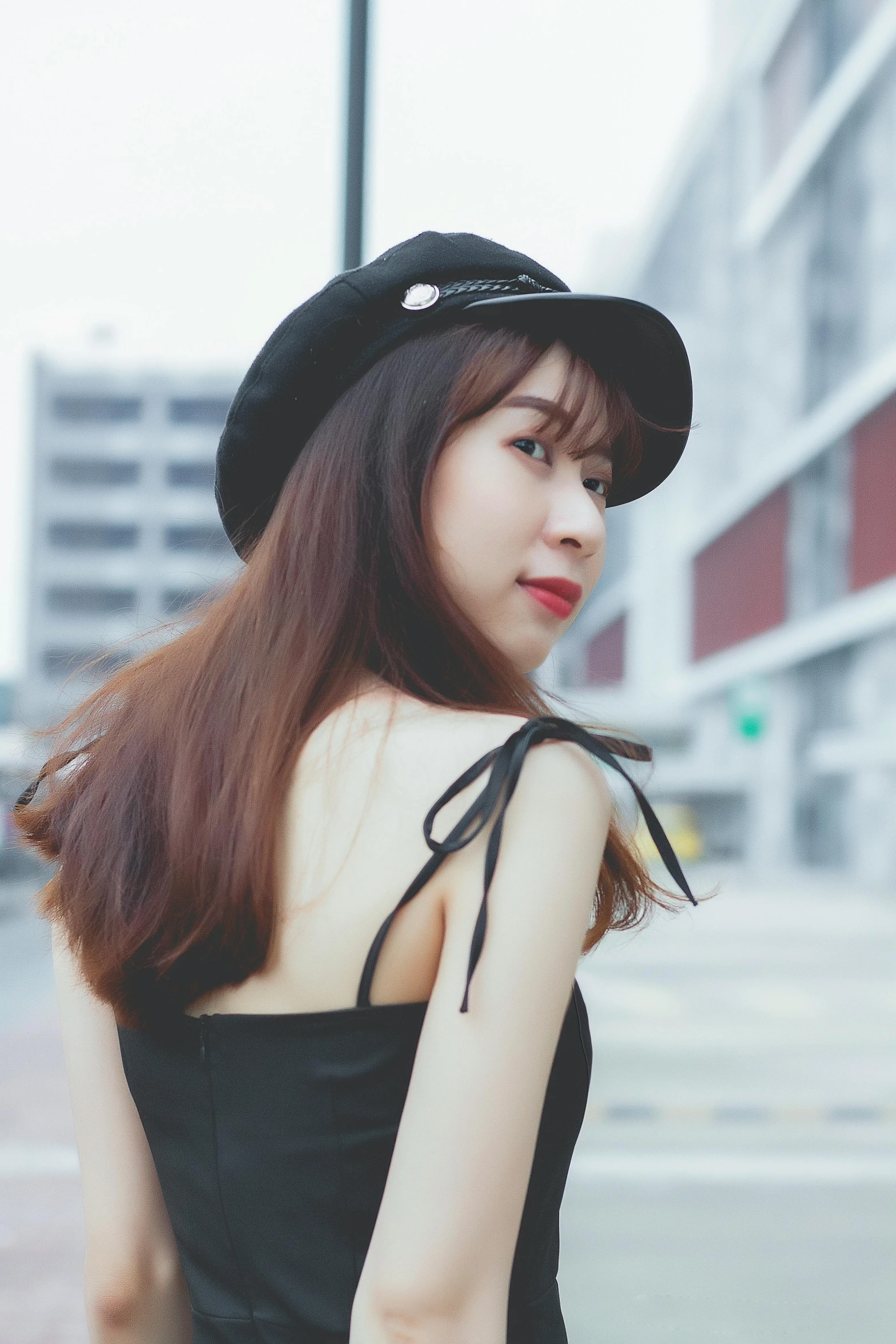 an attractive young woman wearing a black hat