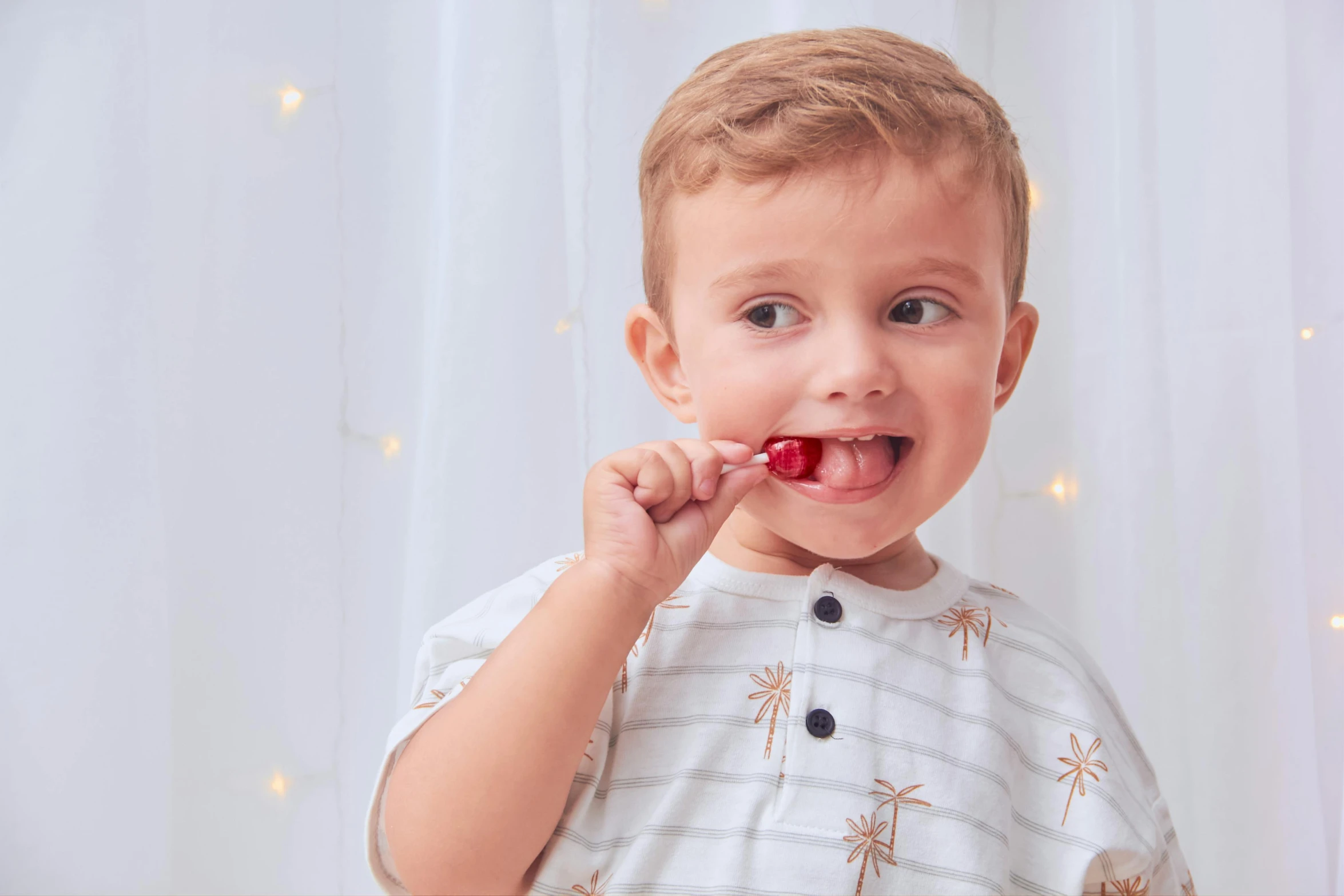 a small child is chewing on a stick