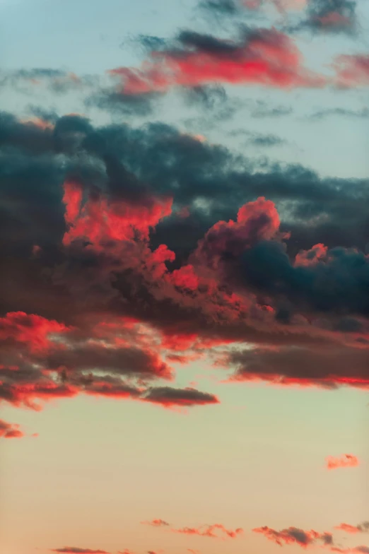 a view of the sky as a plane flies low in the background