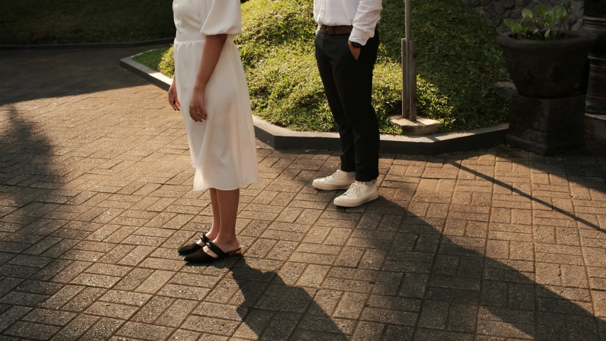 two women standing outside looking off into the distance