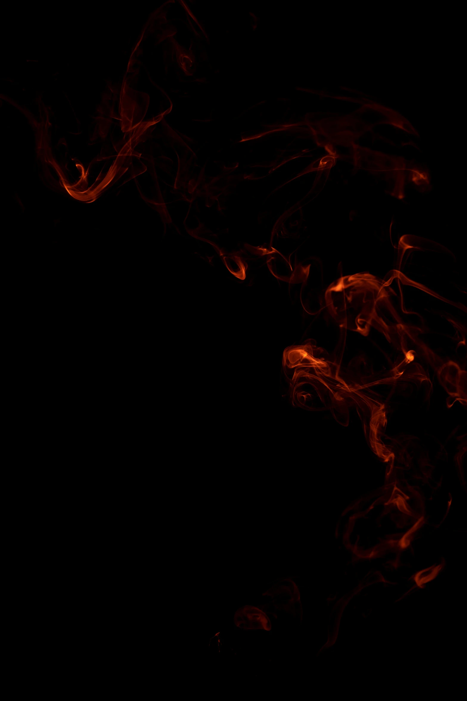 red paint in the dark, swirling on a piece of paper