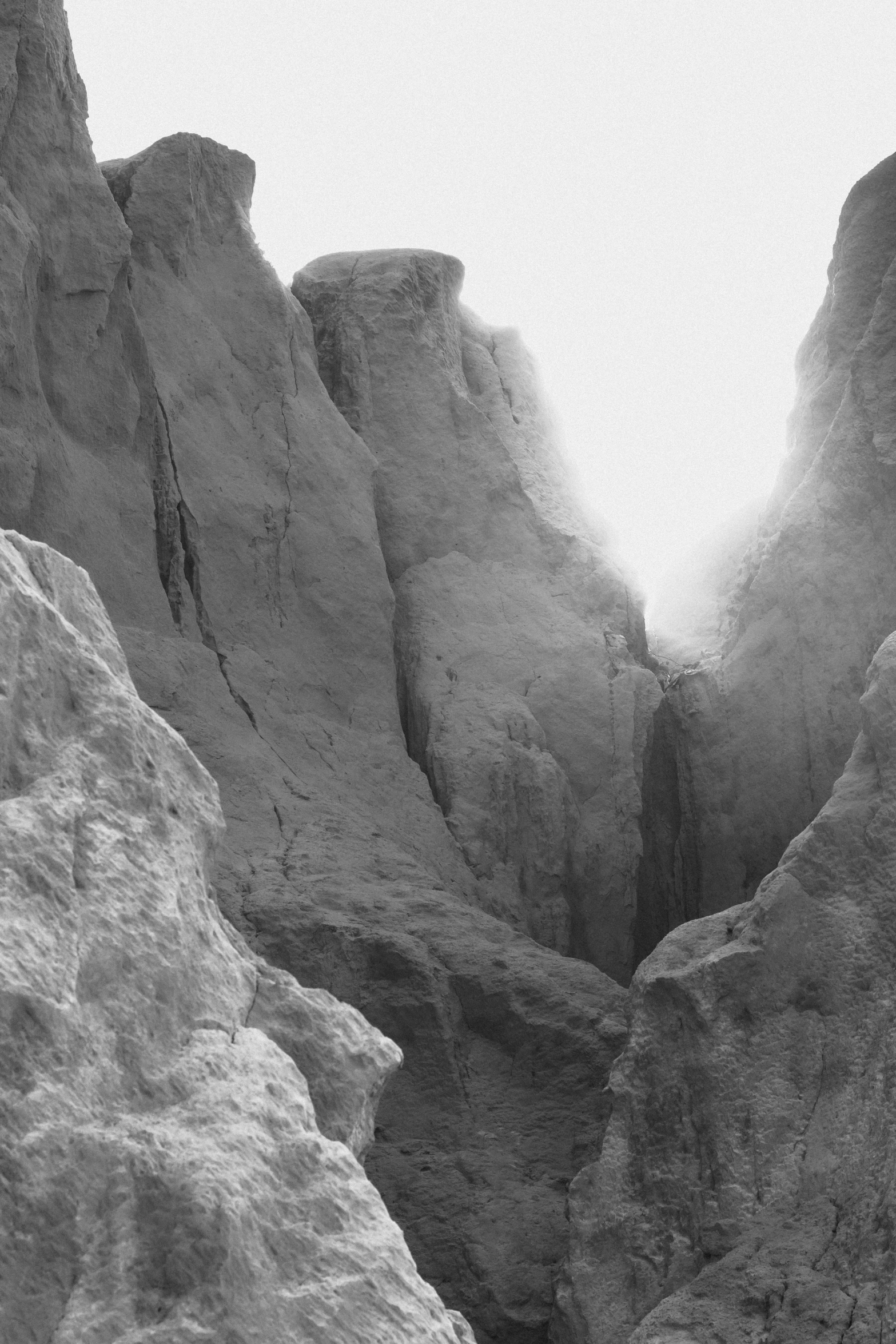 man hiking in the mountains alone and looking at soing