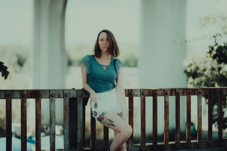 a girl poses for a po on the bridge