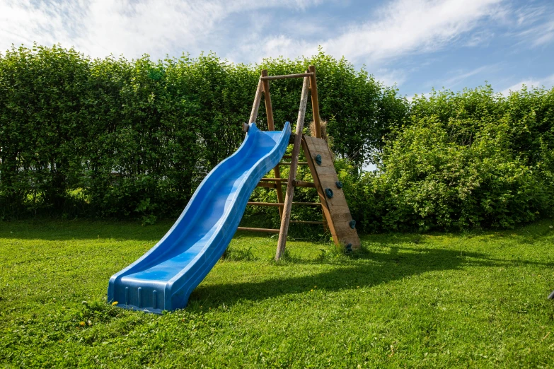 a blue slide set up in the backyard