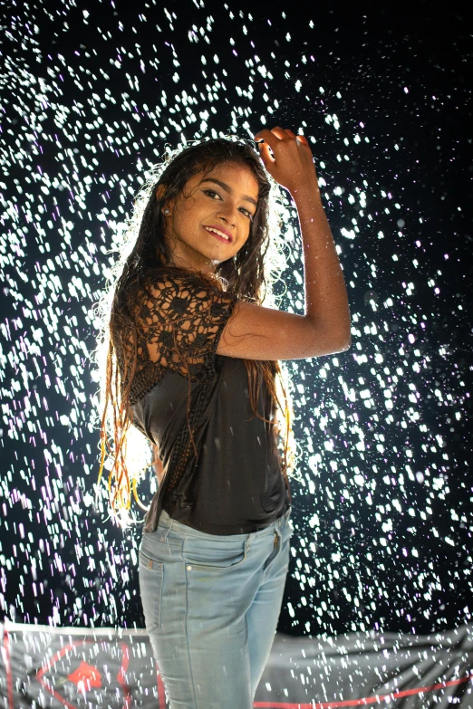 a woman standing under a colorful light display