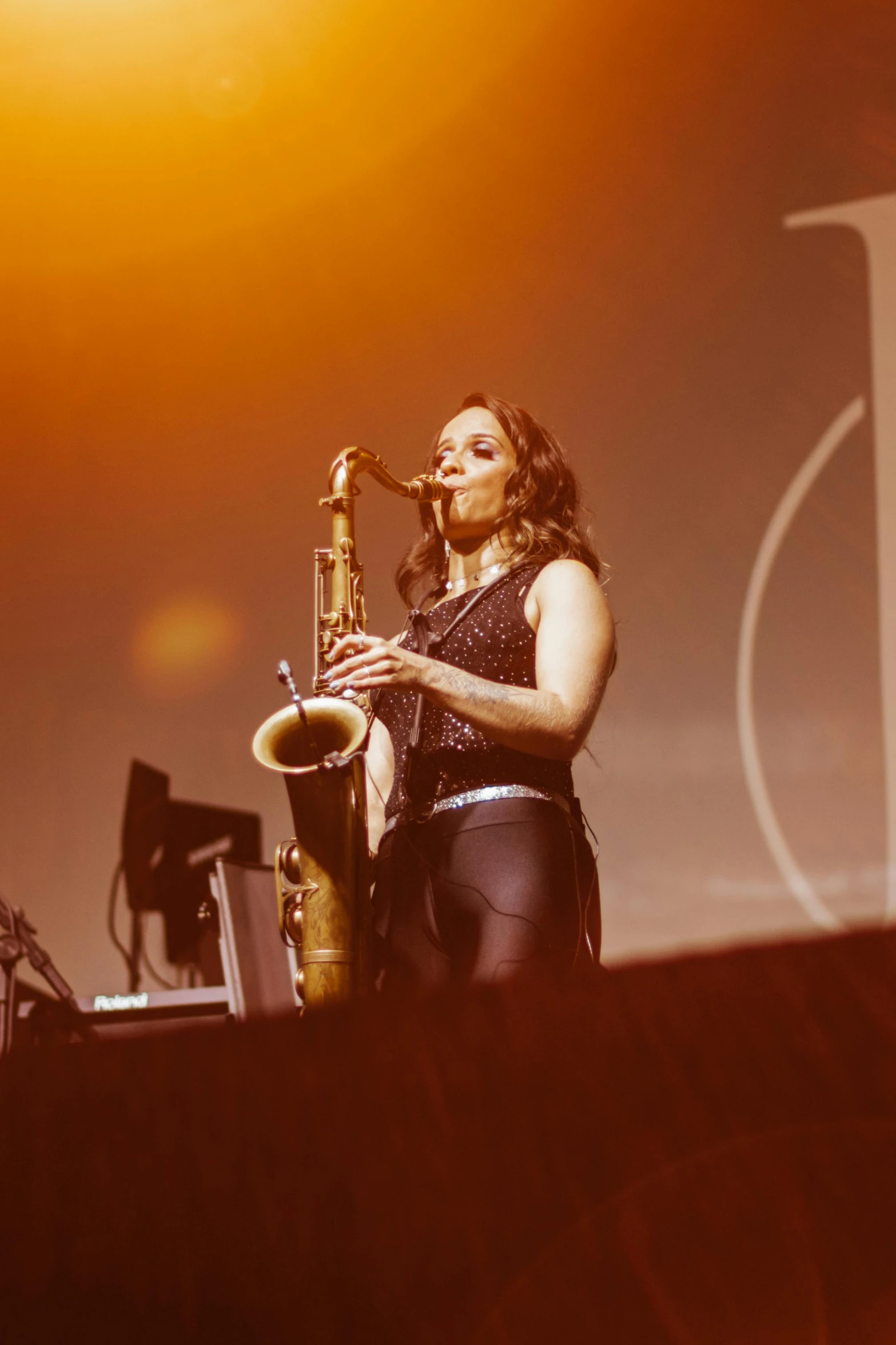 a woman with long hair plays the trumpet