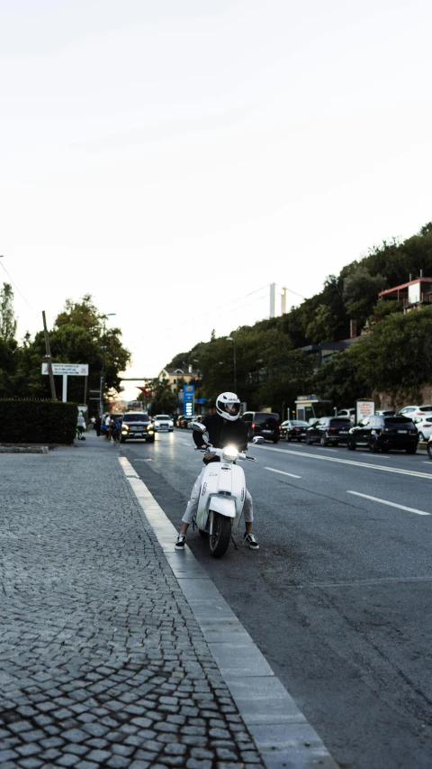 motorcycle riding down the street with people sitting on it