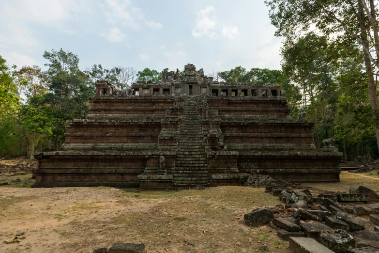 an old building sits surrounded by trees in the jungle