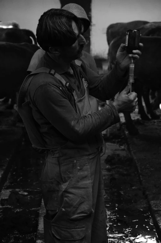 a man standing in front of a cow pen