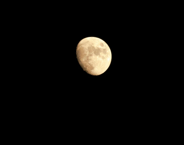 the full moon is seen through the black sky