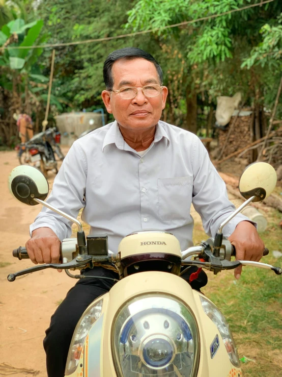 a man wearing glasses riding a motor bike