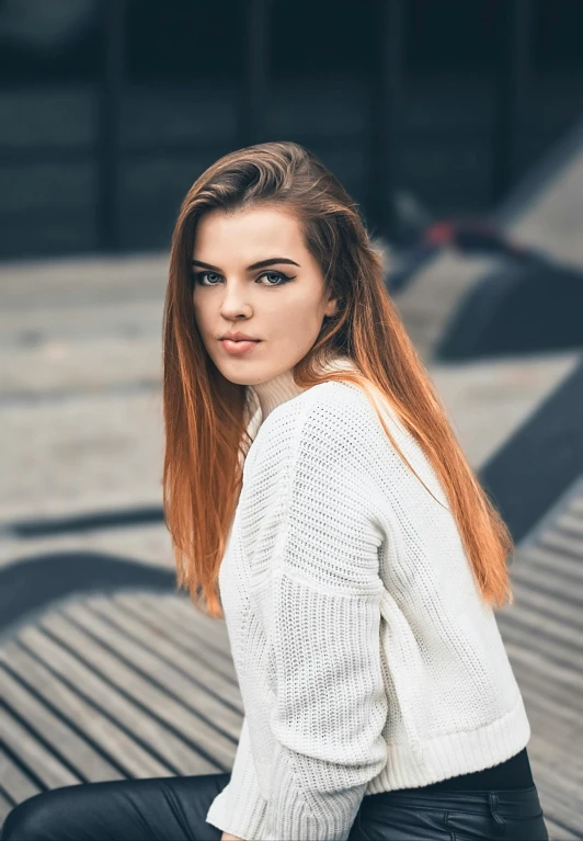 an image of woman with beautiful red hair sitting down