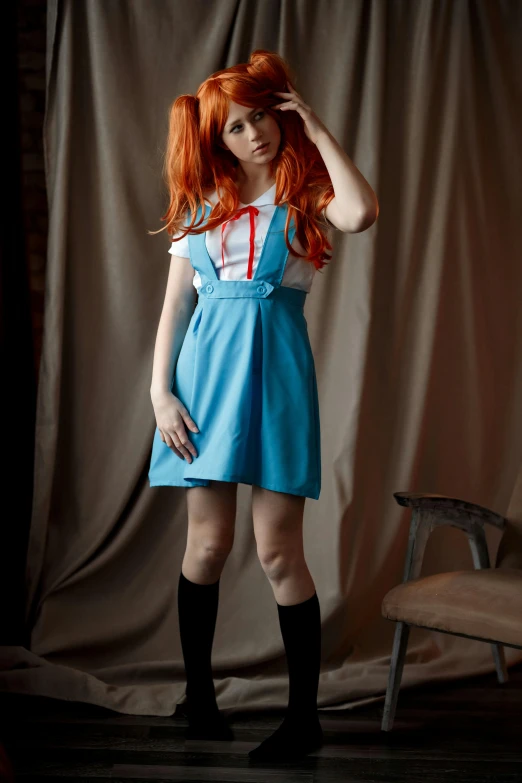 woman with red hair wearing a dress in a dark room