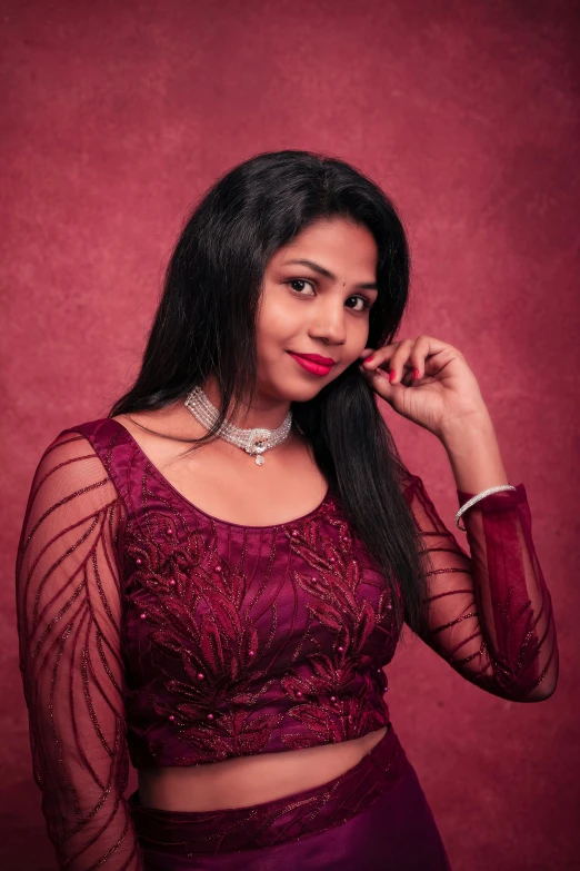 an indian woman poses with her long hair in a purple pose