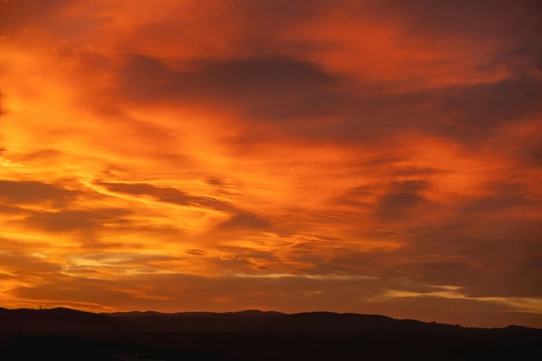 an orange and red sky is captured in this picture