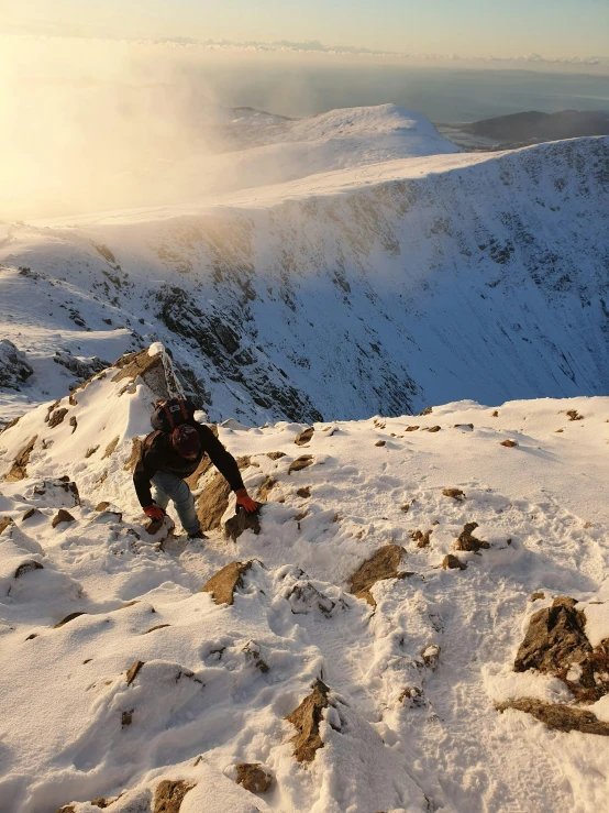 a man standing on top of a snow covered mountain