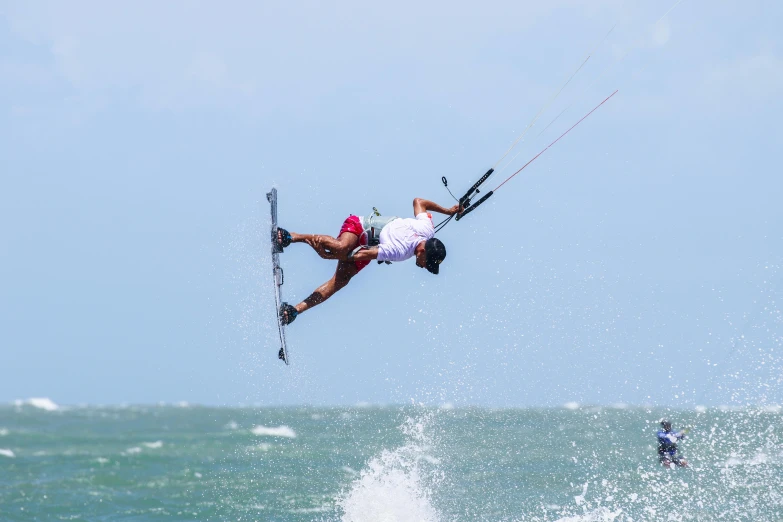 the man is wakeboarding and parasailing in the ocean