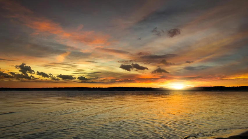 a sunset over a large body of water